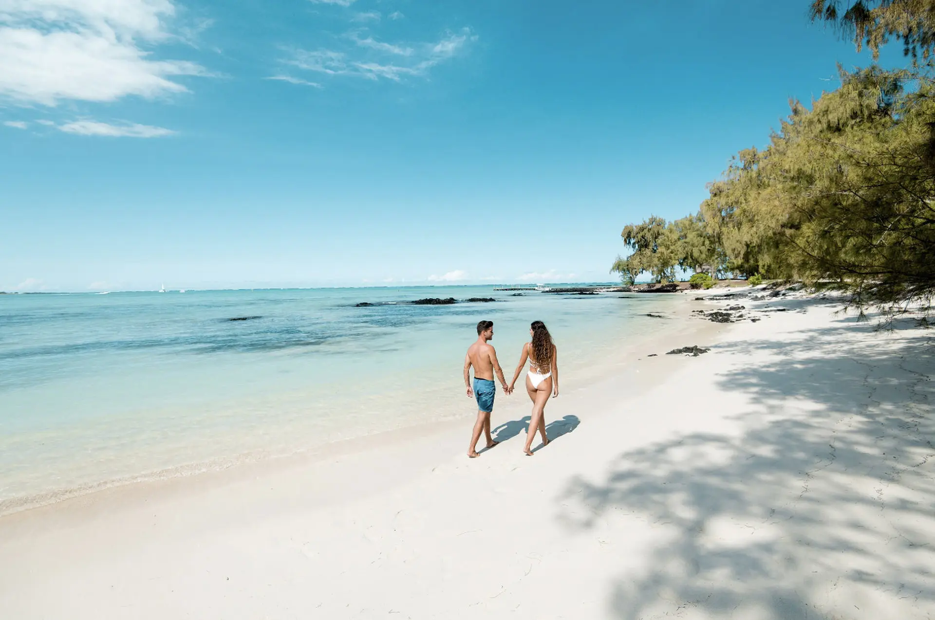 Par går tur på den kridhvide sandstrand på Shangri-La Le Touessrok, Mauritius