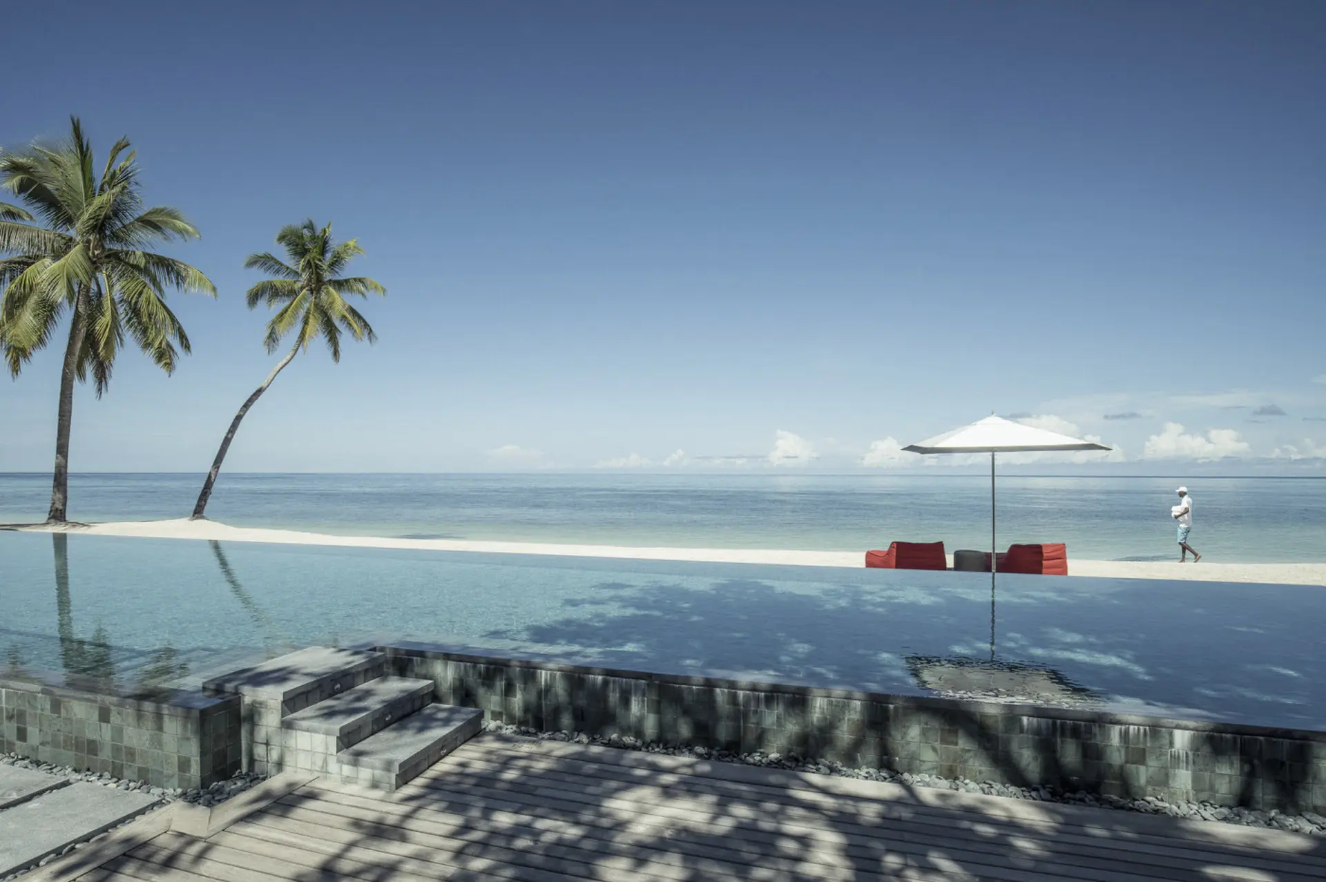 Poolområde ved vandet på Four Seasons Resort at Desroches Island, Seychellerne
